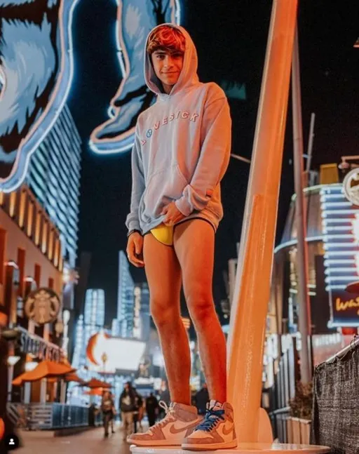 Prompt: teenage boy wearing a yellow speedo