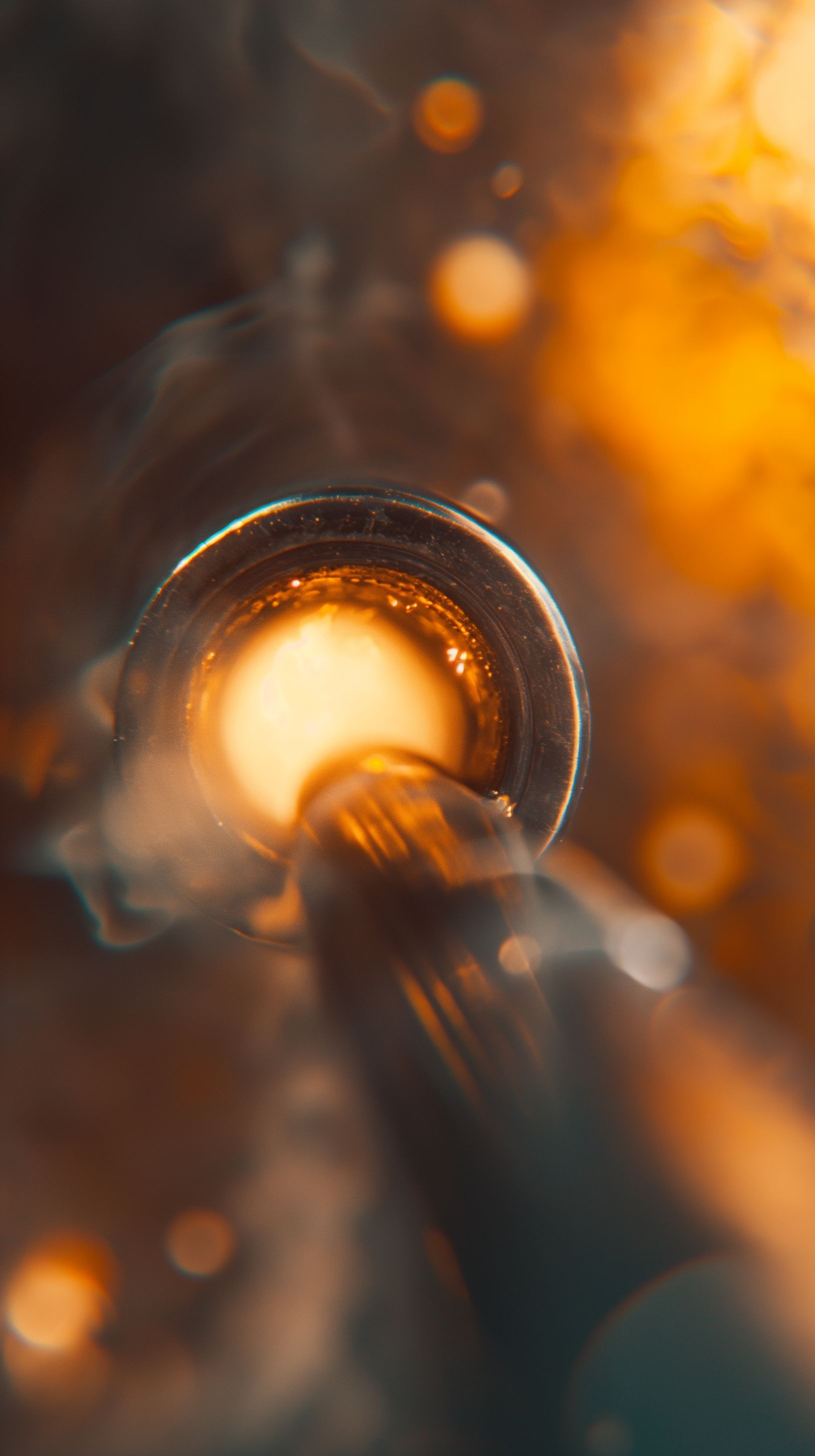 Prompt: close up shot looking into the smoking barrel of a gun, orange glow on the rim, bullet coming towards the focus of the image from the barrel, everything fades dramatically smaller away from the high focus on the muzzle of the gun --ar 9:16 --v 6.0